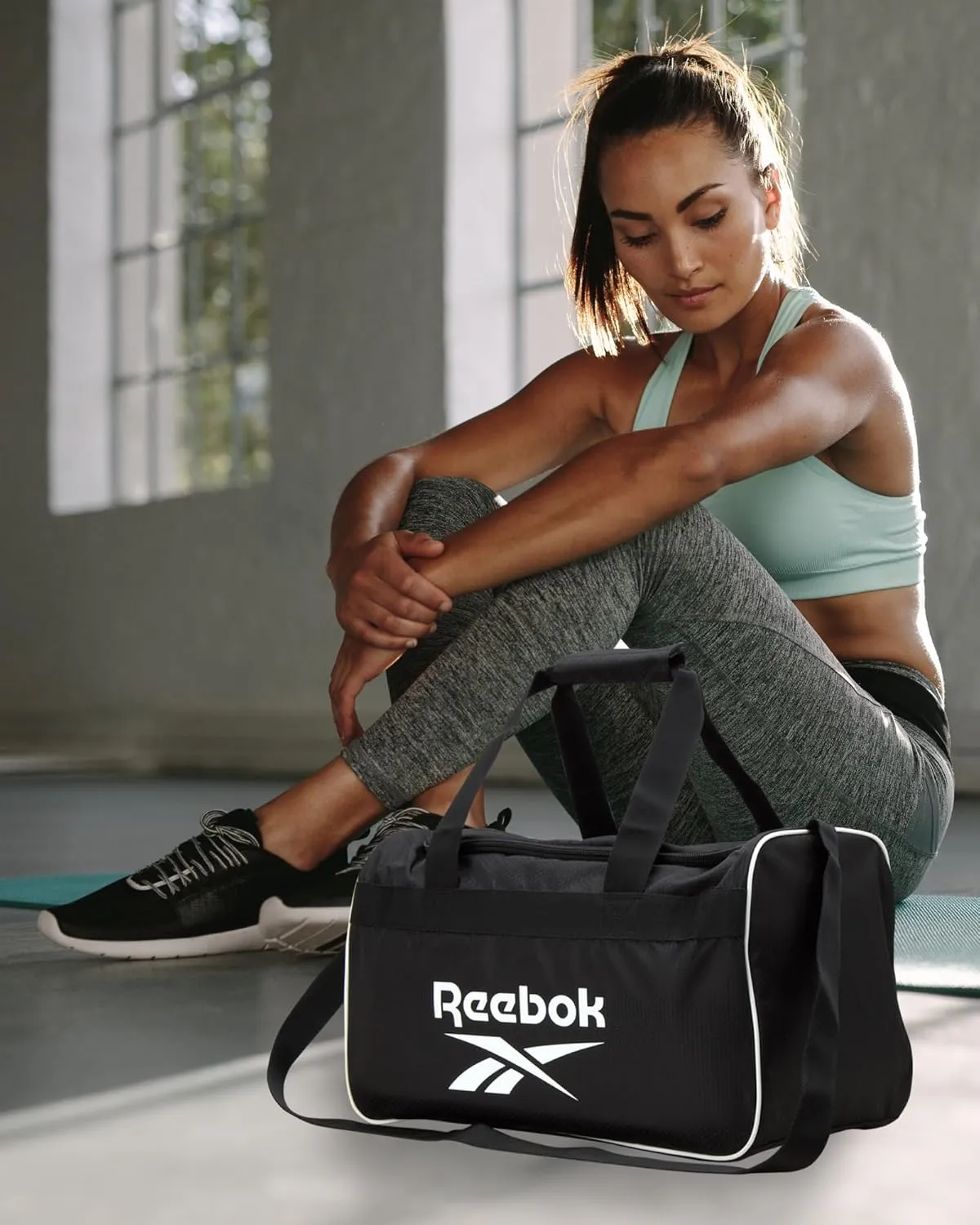 Reebok Duffle Bag – Gym Bag for Women & Men, Carry On and Overnight Duffle for Travel & Fitness, Size Small, Warrior II Black with Contrast Logo
